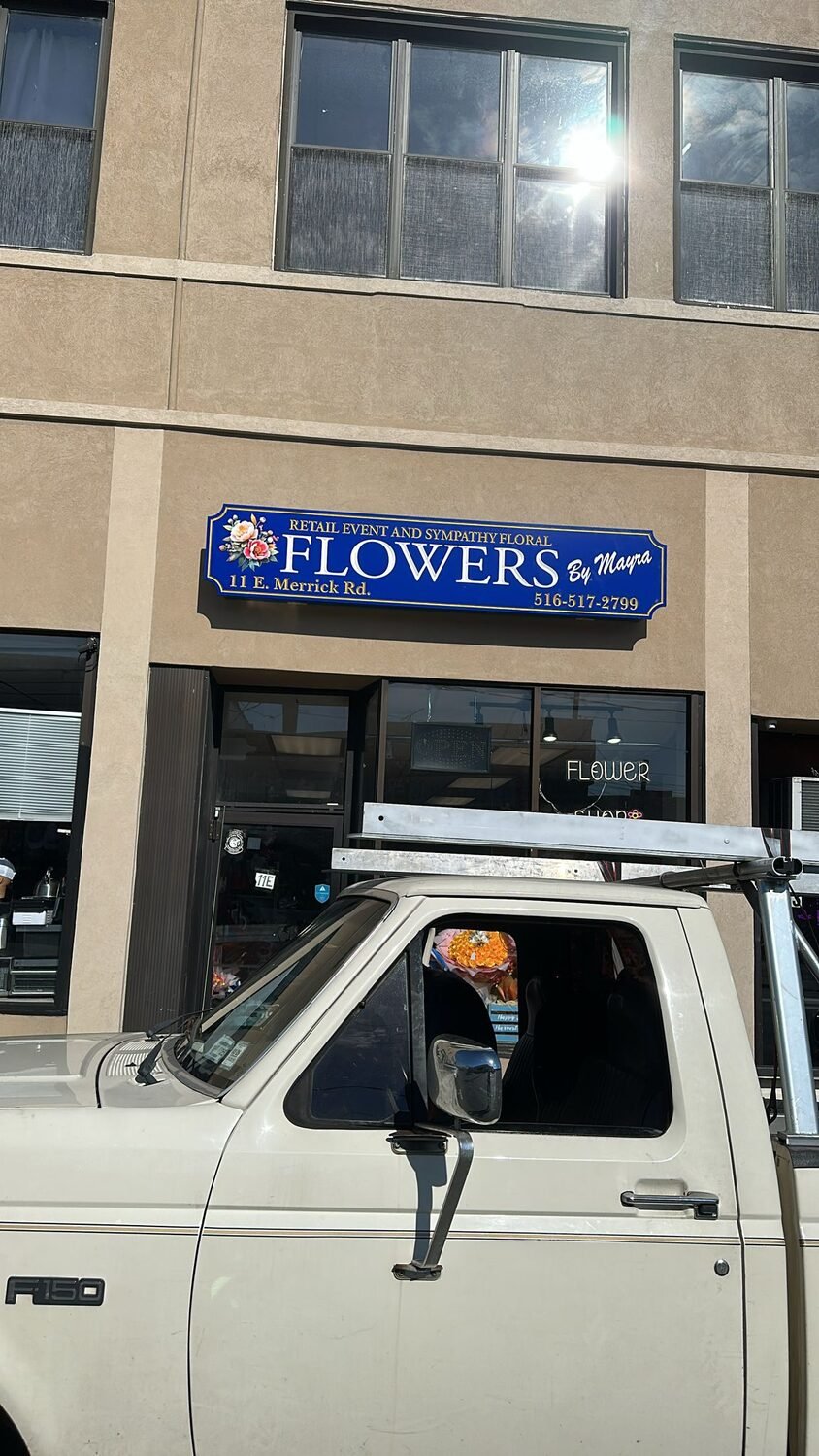 Carved storefront sign for Flowers by Maypa