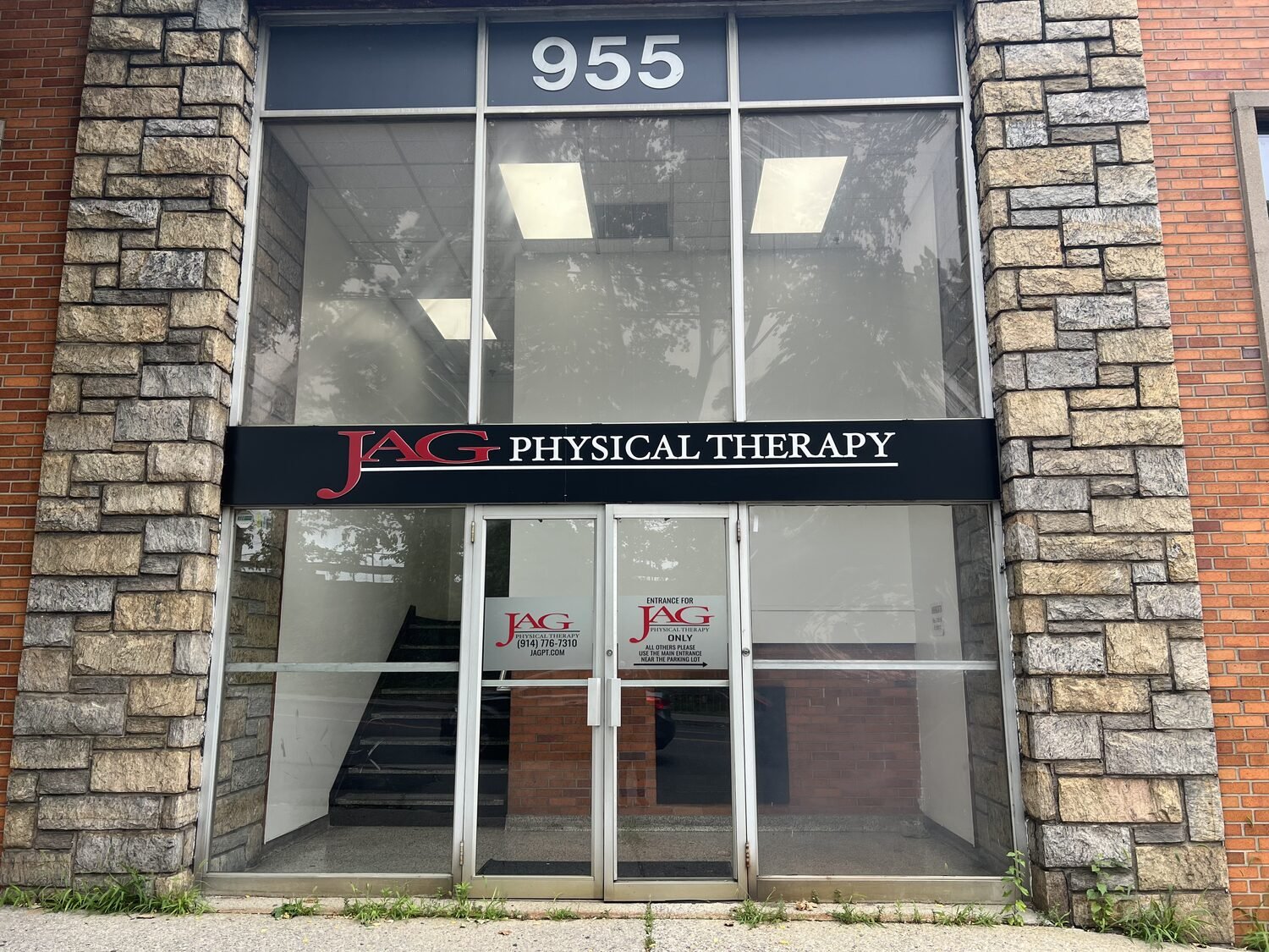 Aluminum pan sign over the entrance for JAG Physical Therapy