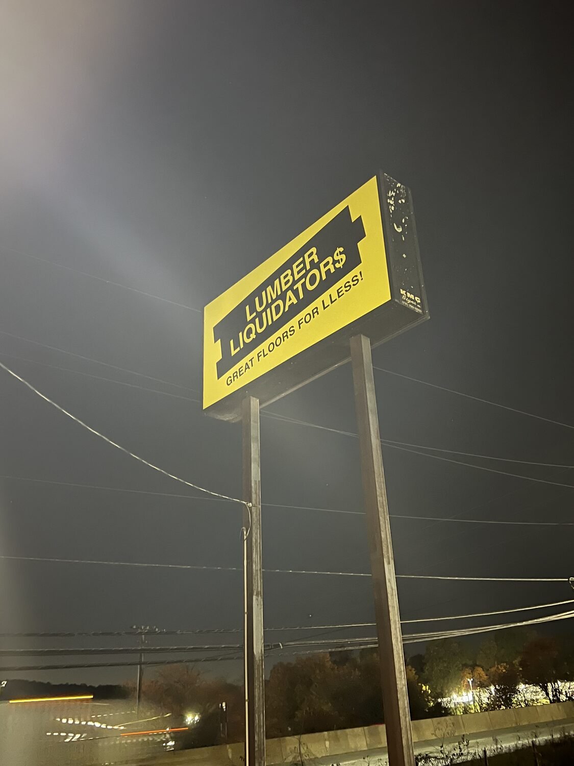 Lit pylon sign at night for Lumber Liquidators